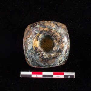 The same bottle, viewed from the top, post-conservation. The glass is visible and significant degradation is apparent.