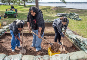 Surry County High School students excavate one of the squares southwest of the Archaearium.