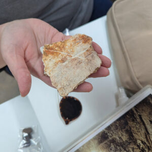 Assistant Curator Lauren Stephens holds a piece of exterior plaster from the 1617 church.